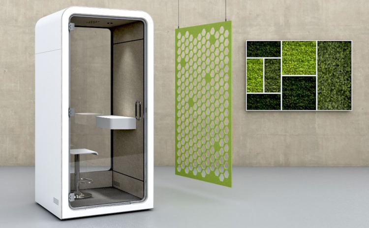 modular office furniture like phonebooth is placed on floor with green mesh and wall painting